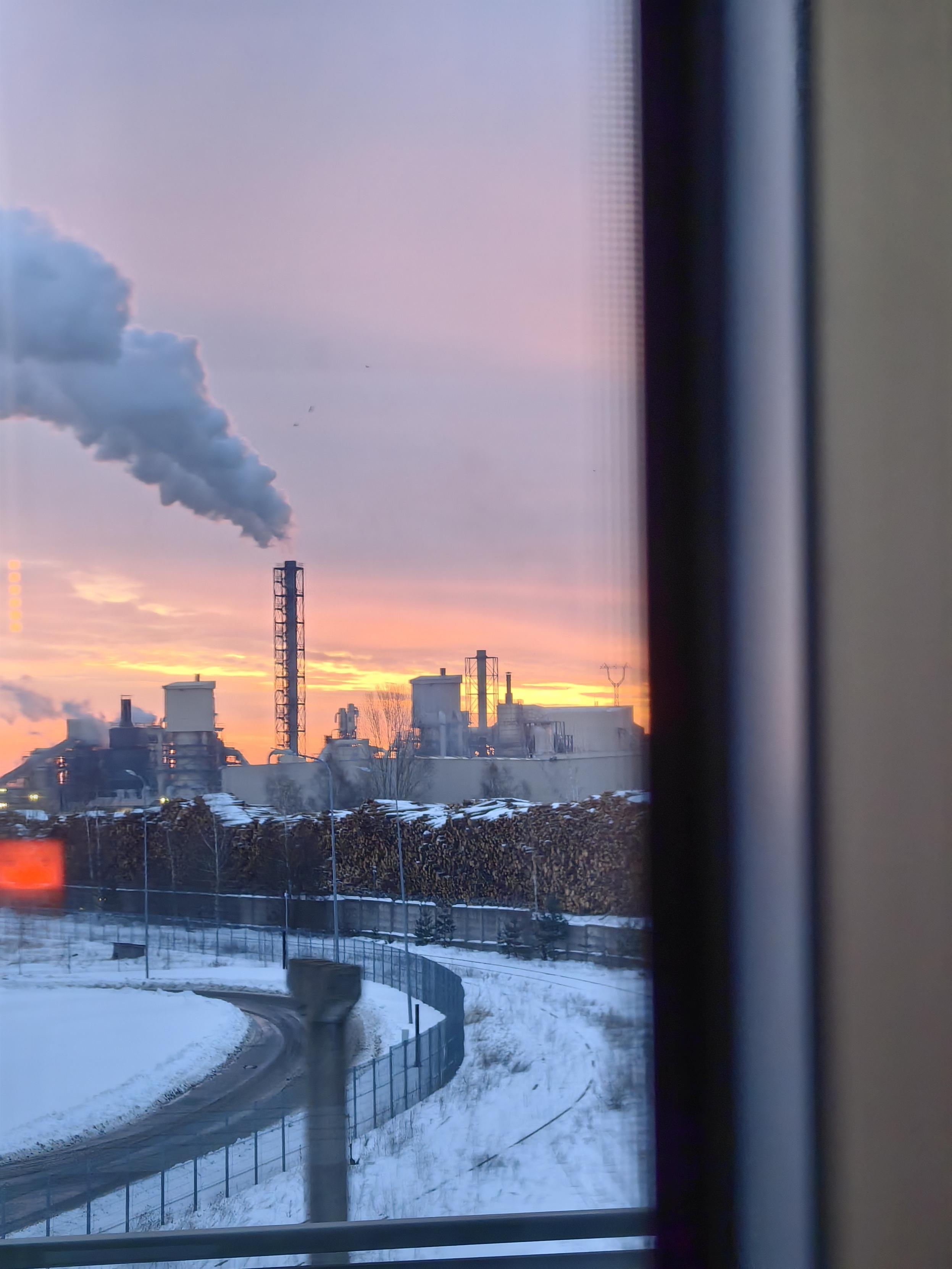 Chimney of plywood factory in sunrise