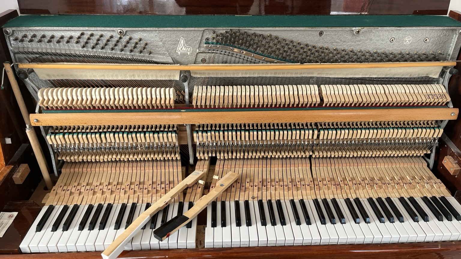 An open piano with visible strings and keys